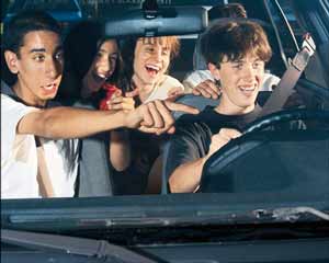 Teen driver with laughing passengers